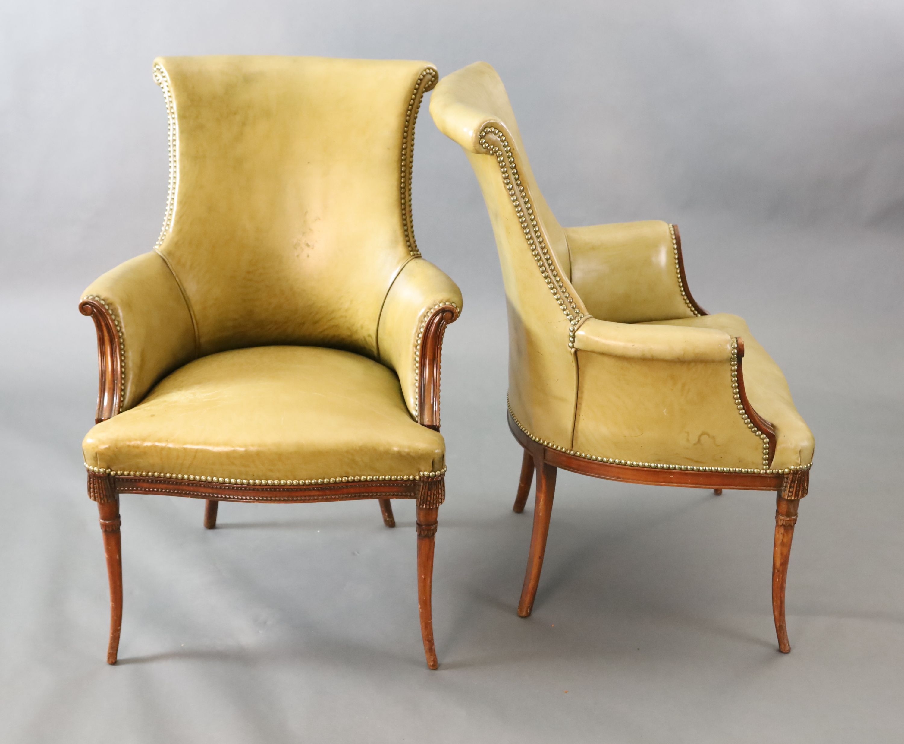 A pair of Regency style leather and mahogany library chairs, W.2ft 3in. D.2ft 3in. H.3ft 2in.